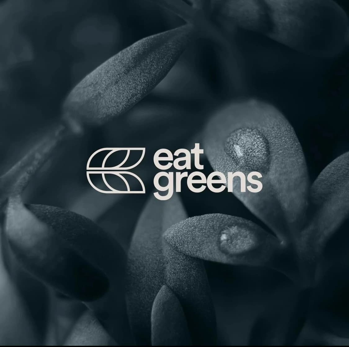 Eat Greens white outline leaf emblem and wordmark over leafy photography