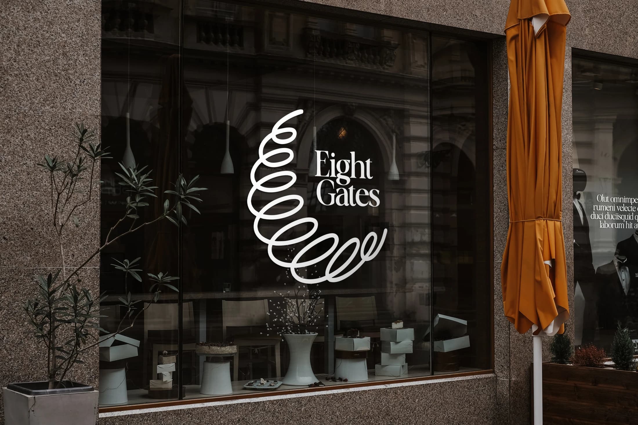 Eight Gates window-branding mockup with a looping white emblem